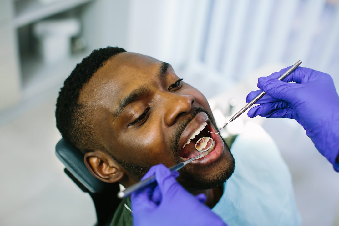 African male patient getting dental treatment in dental clinic
